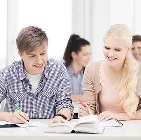 students writing on notebook