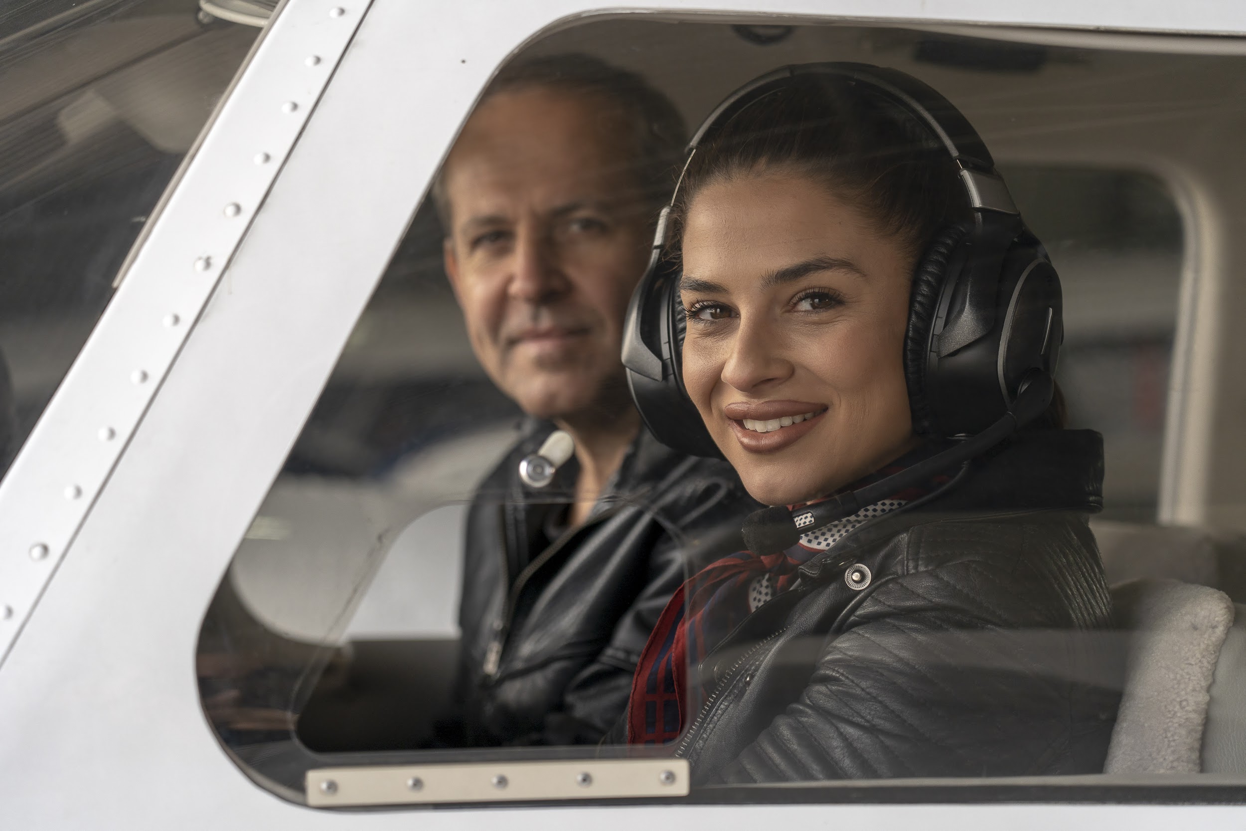 young woman trainee pilot with headset preparing to fly