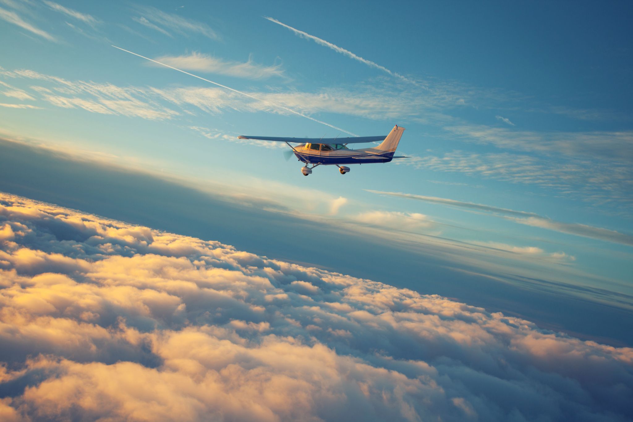 single engine airplane flying in the sunset