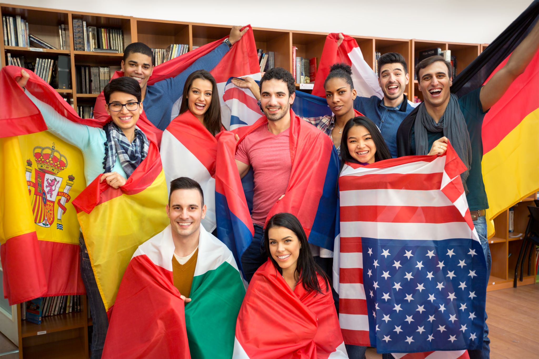 happy students presenting their countries with flags