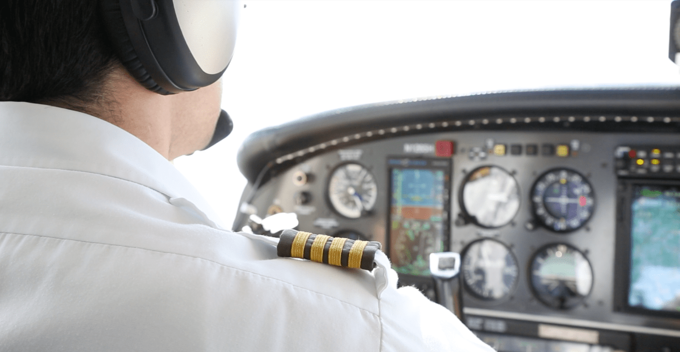 man pilot sitting in airplane cockpit
