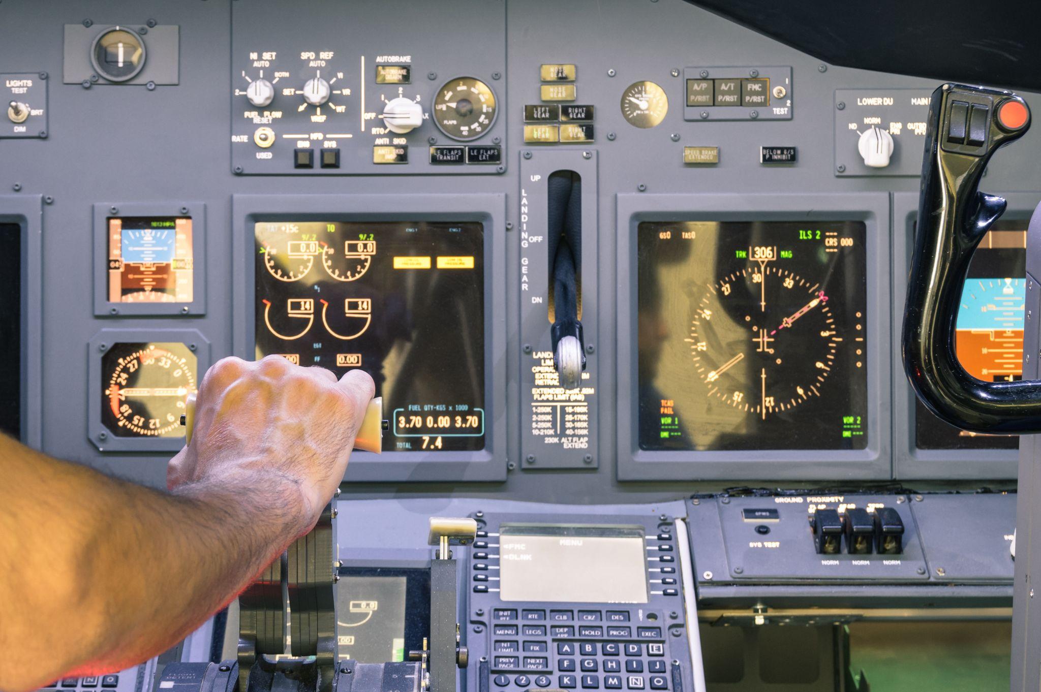 Captain hand accelerating on the throttle in commercial airliner