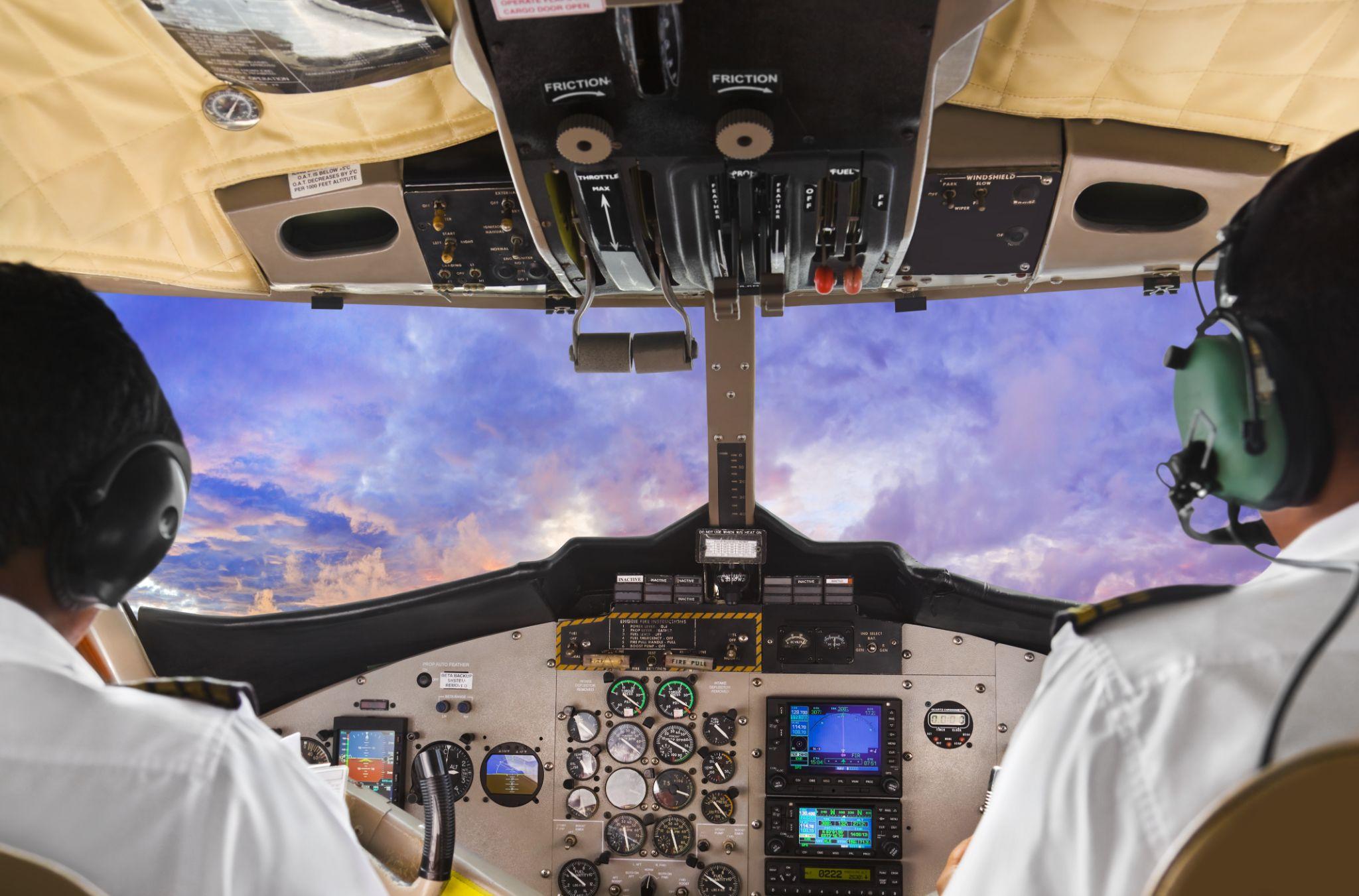 Pilots in the cockpit during a flight with commercial airplane.