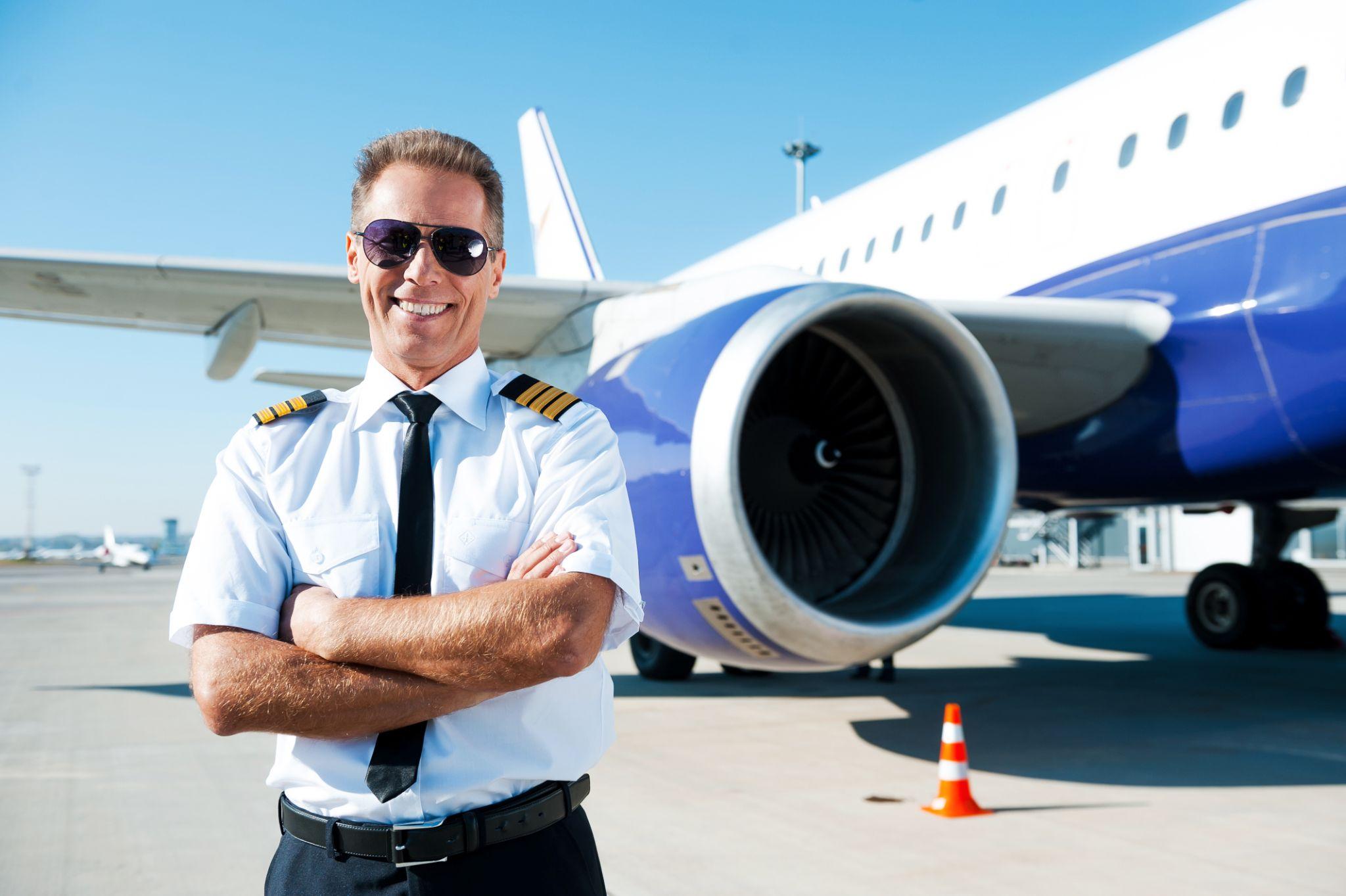 Confident pilot locating near plane