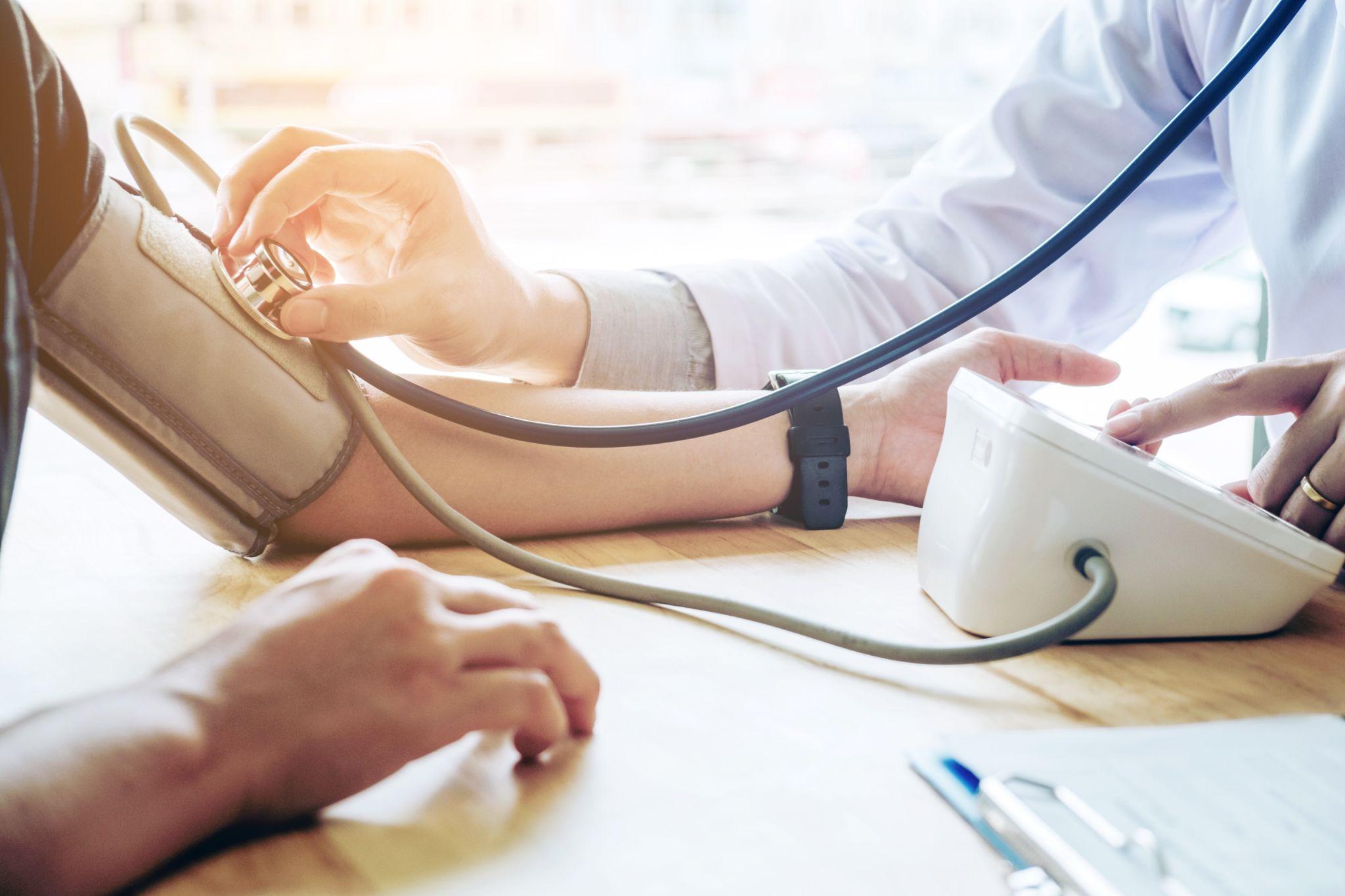 Doctor Measuring arterial blood pressure woman patient on arm