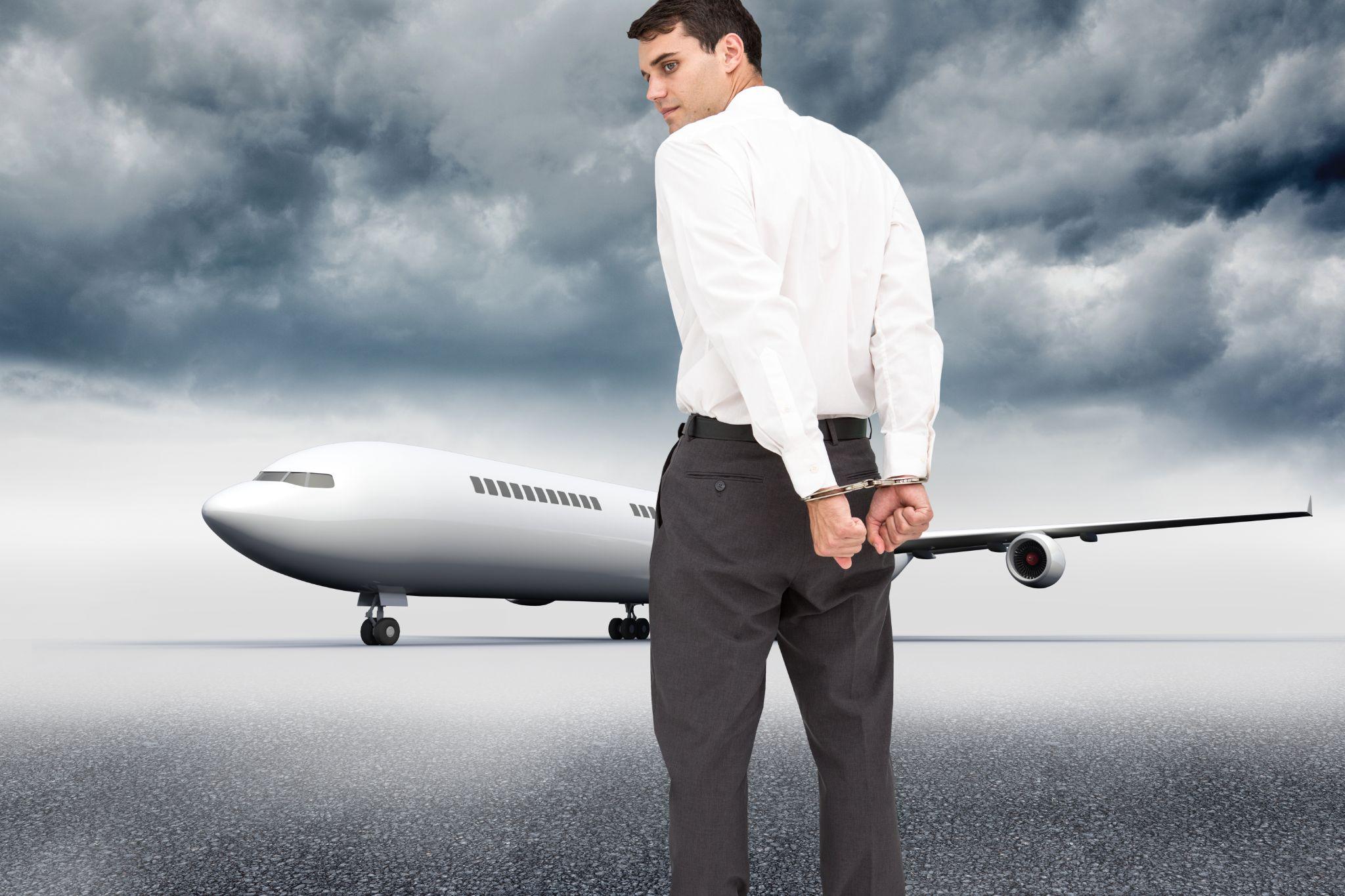 unsmiling businessman wearing handcuffs