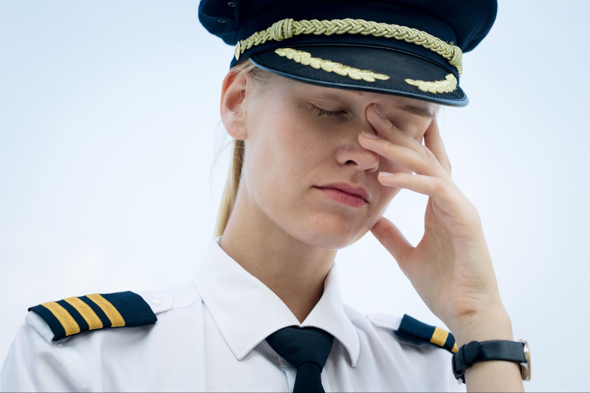 Pilot worker at the airport tired and stressed out from work.