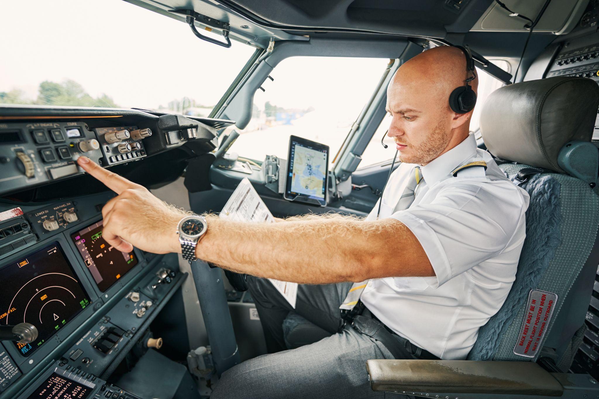 Experienced pilot checking flight controls before the departure.