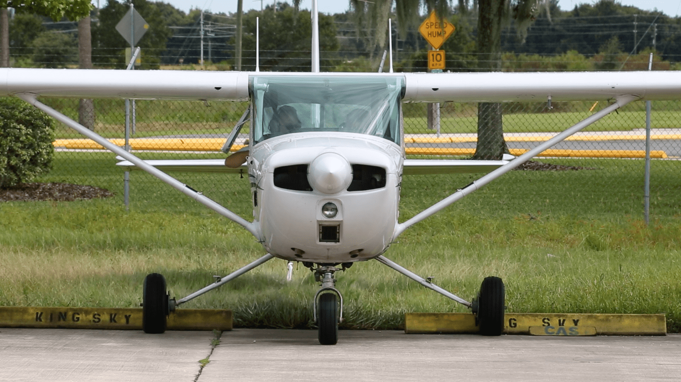 Small private airplane on tarmac.