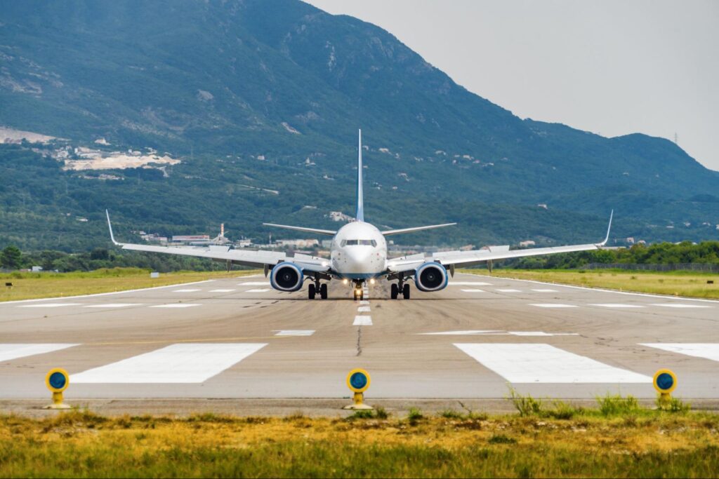 Sunny view of airplane taking off from airport of Tivat, Montenegro.