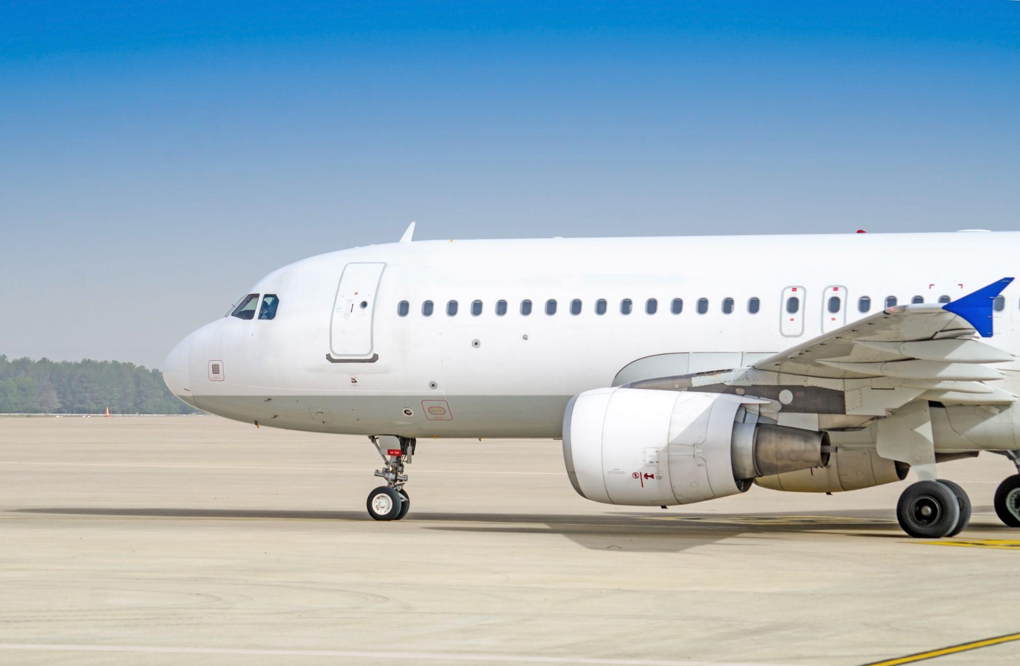 White Airbus A320 on tarmac.