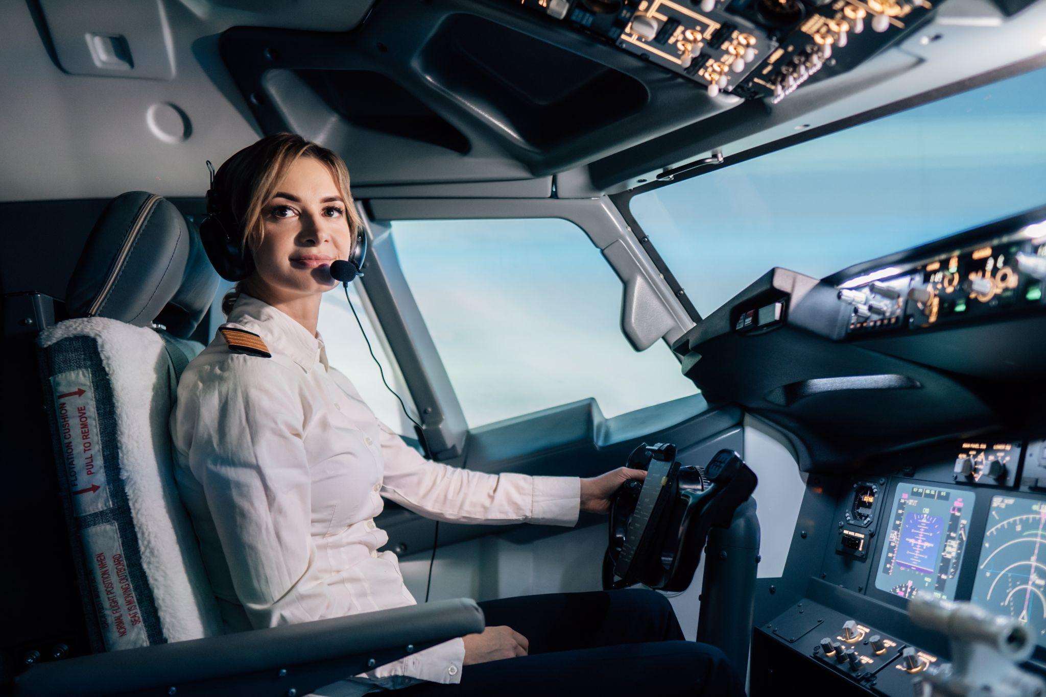 Female flight captain in cockpit.