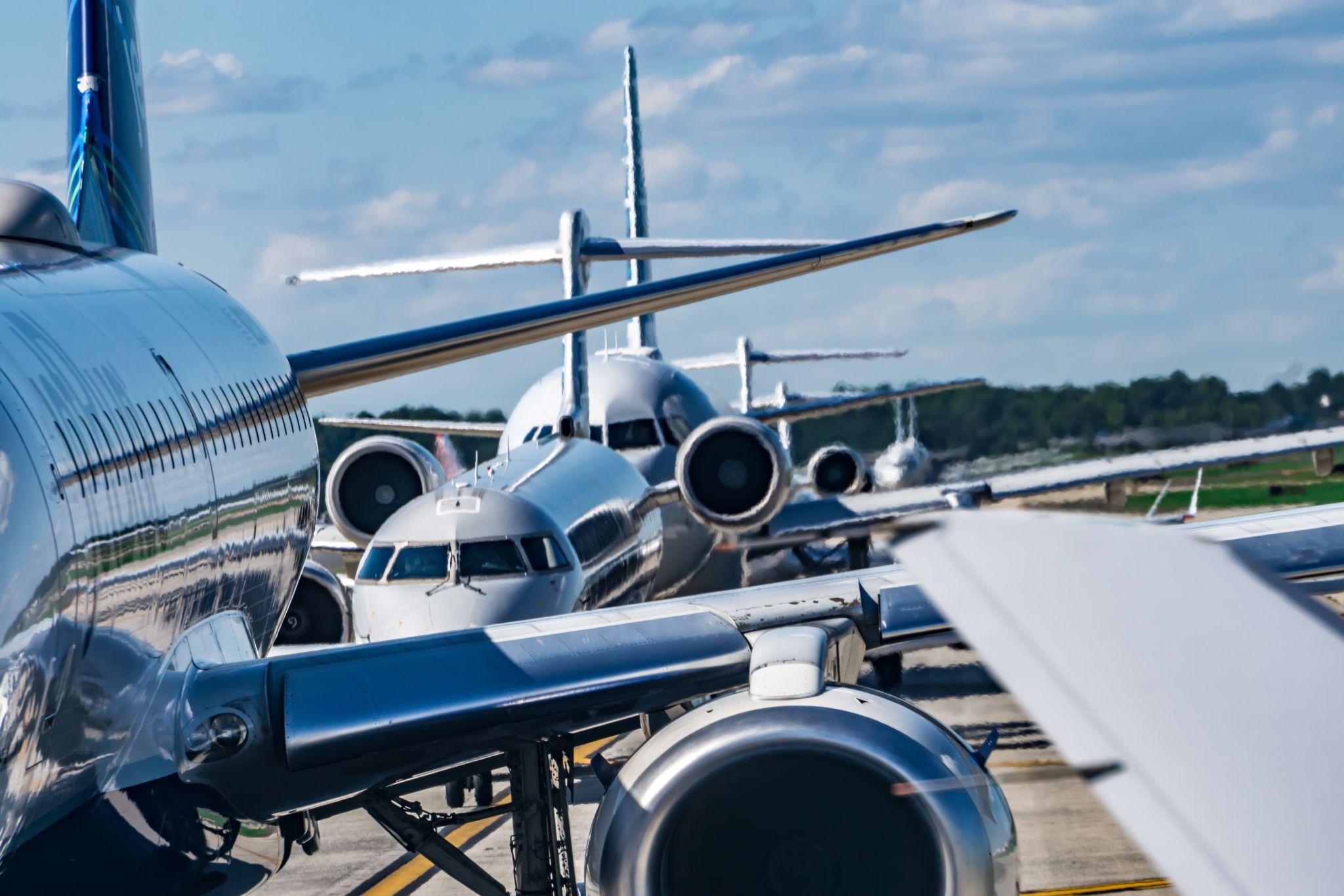 Busy airport tarmac traffic before airplanes take off.