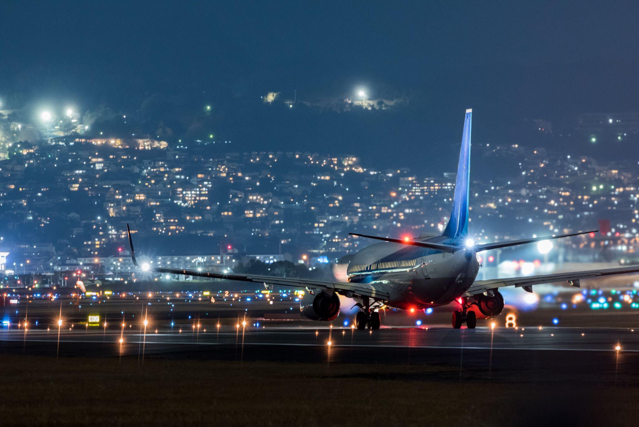 B737NG airplane at night on tarmac.