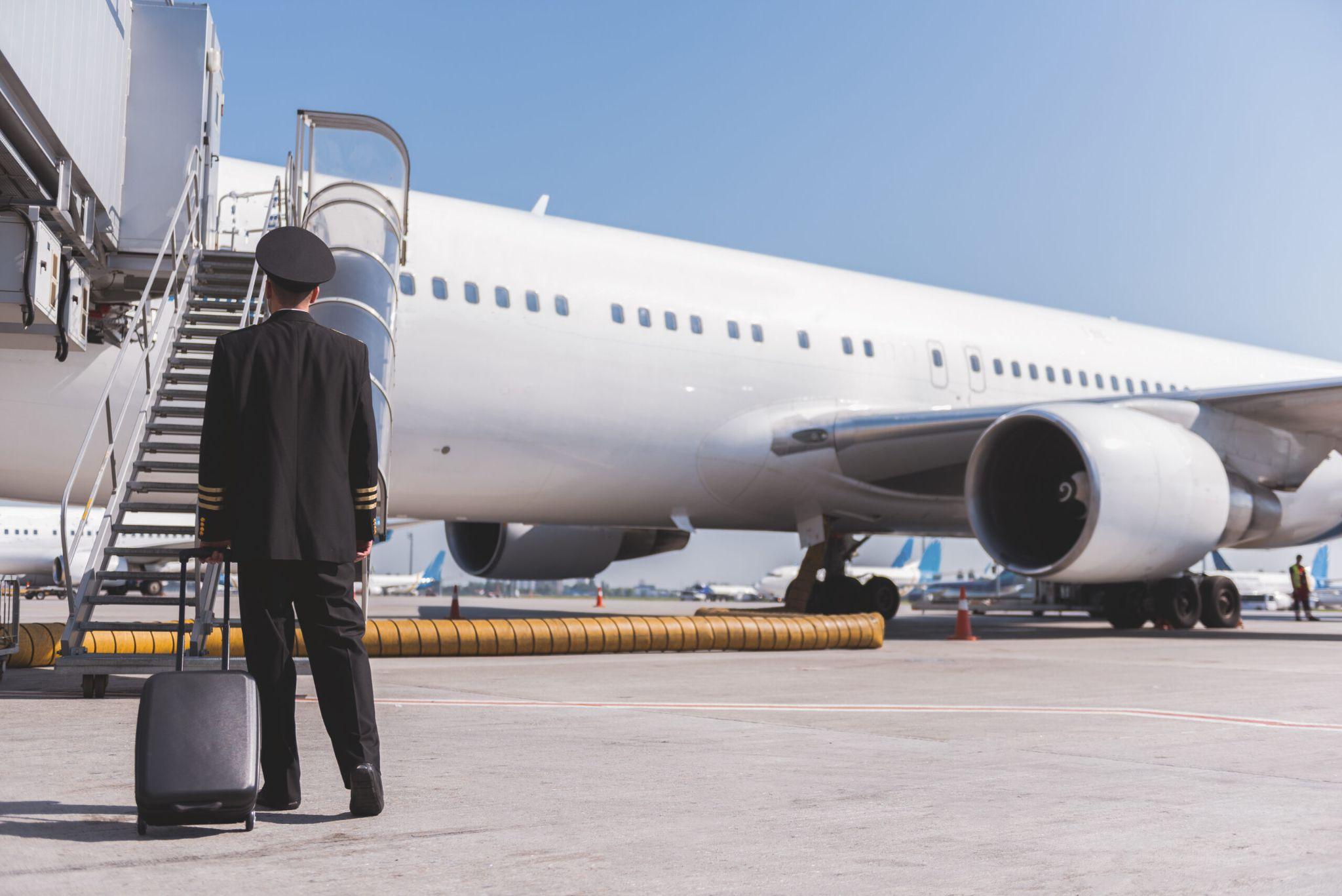 Pilot entering airplane with stairs.