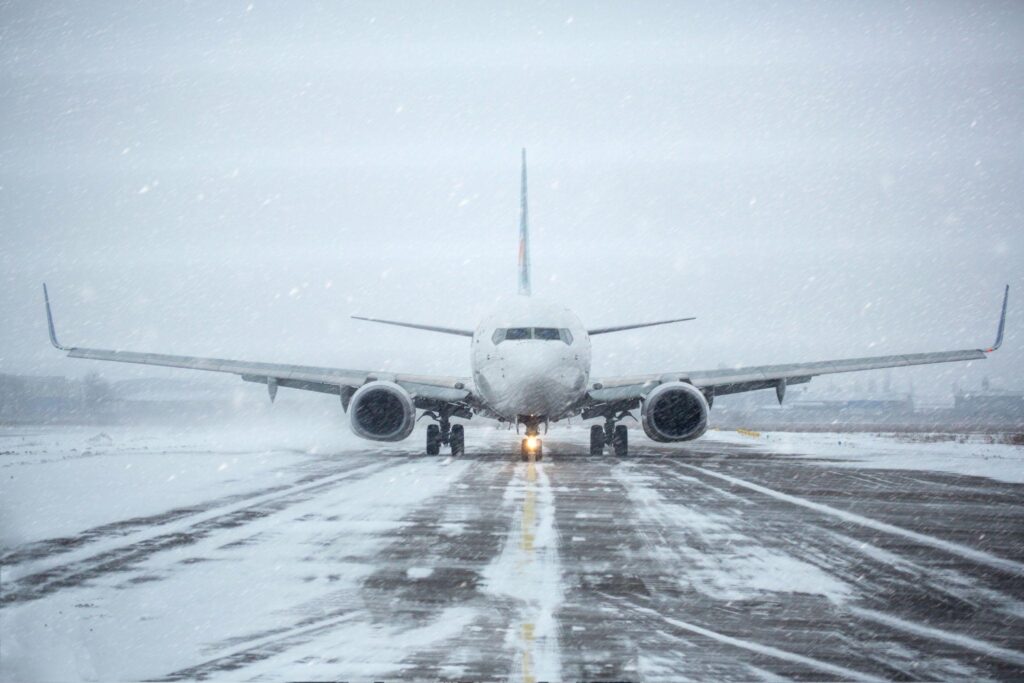 Airliner on runway in blizzard.