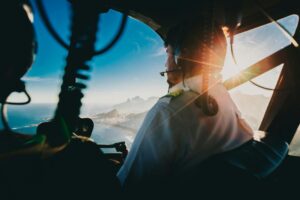 International pilot navigating an aircraft over coastal terrain.