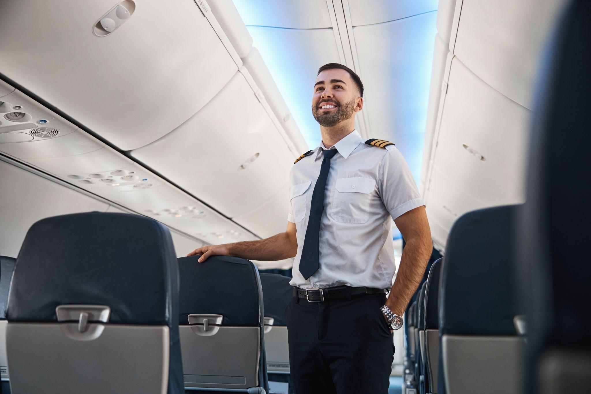 A happy international pilot in the aircraft cabin.