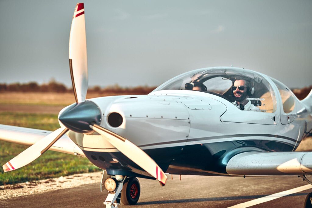 Man and woman in the cockpit of a light aircraft.