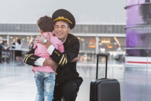 Cheerful smiling father embracing boy.